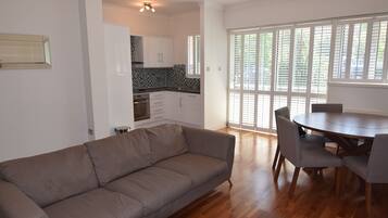 Deluxe Apartment, 2 Bedrooms, Accessible, River View | Living area | Flat-screen TV