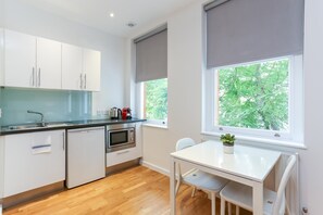 Deluxe Studio Apartment | Private kitchen | Full-size fridge, microwave, stovetop, espresso maker