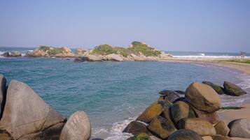Enjoy a serene beach experience with access to the ocean and stunning views of the surrounding landscape.