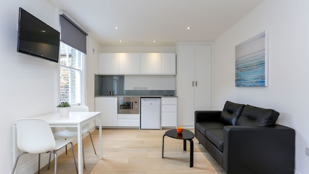 Eine moderne Wohnung mit Küche, Essbereich und Wohnzimmer.