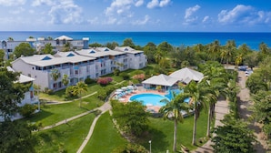A resort with multiple buildings, a swimming pool, and a view of the ocean. - Karibea Sainte Luce hotel (Sainte-Luce)