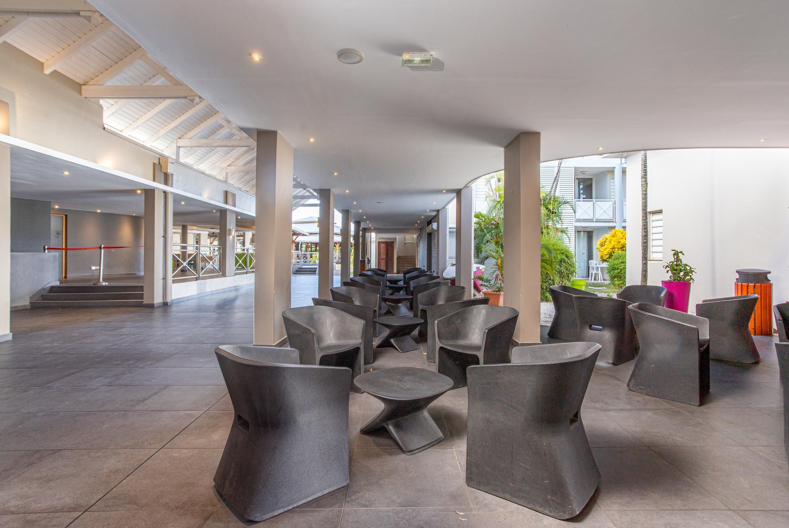 A spacious indoor area with modern seating arrangements and a high ceiling with skylights.