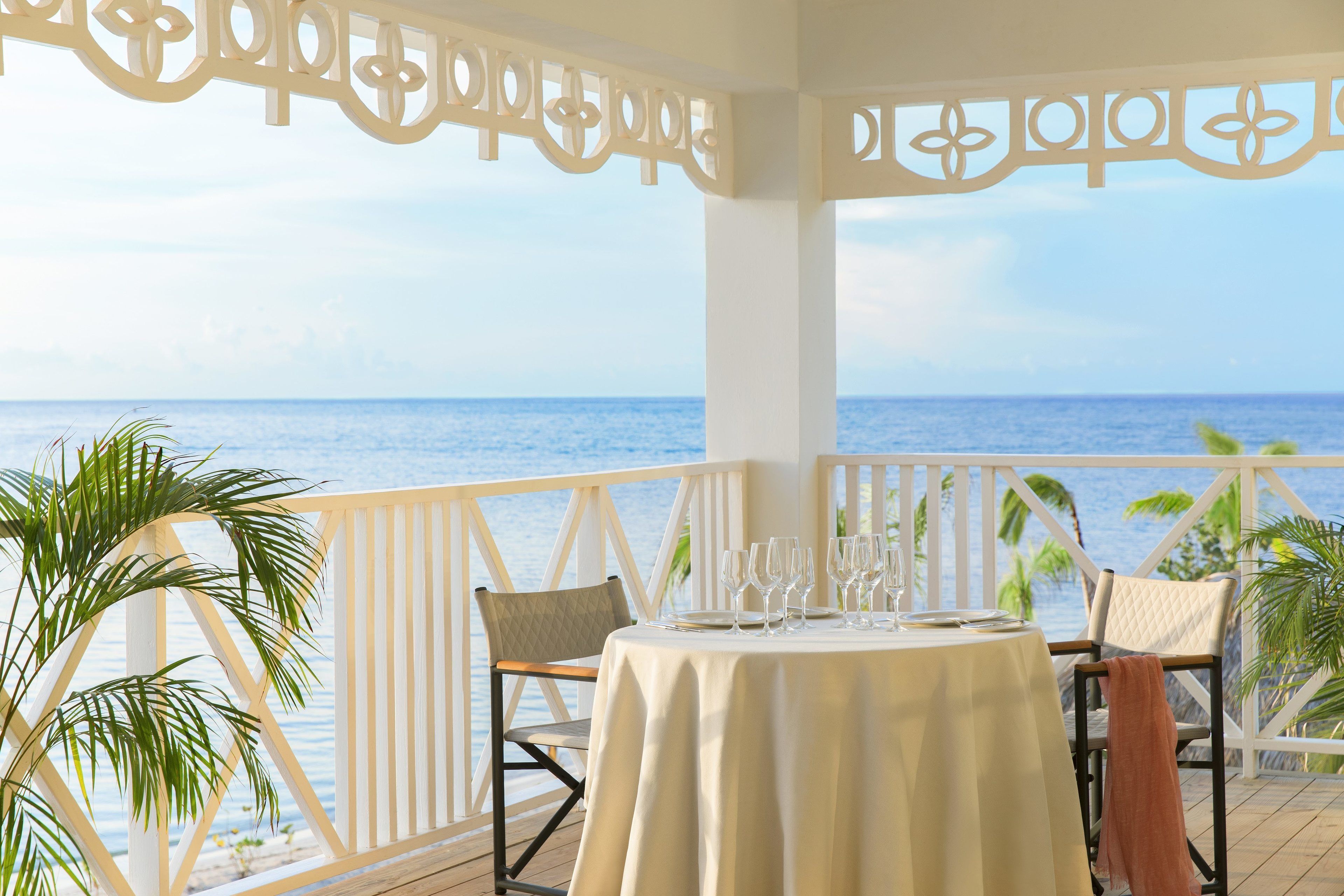A table set for dining with a view of the sea.