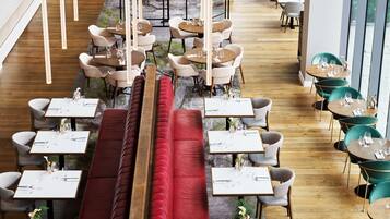 A modern restaurant with wooden flooring, round tables, and cushioned seating areas.