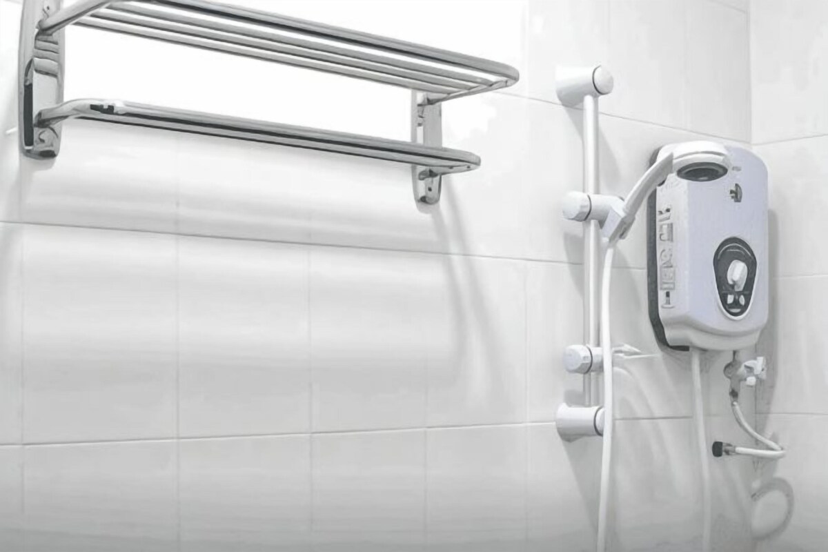 A bathroom with a shower enclosure, a towel rack, and a handheld showerhead.