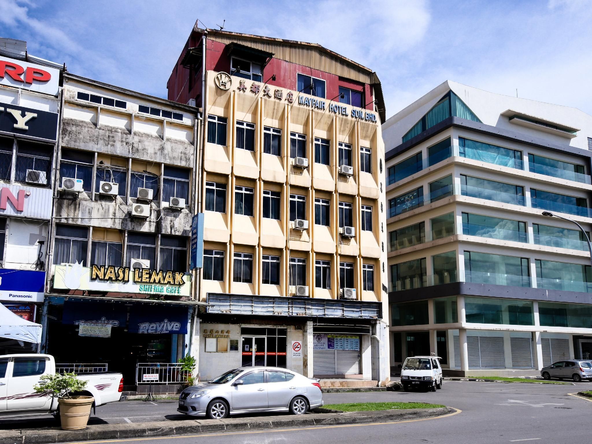 A multi-story building with signage for 'Mayfair Hotel SDN. BHD' and 'Nasi Lemak' restaurant.