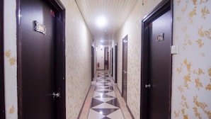 A hallway with doors numbered 203 and 211, leading to rooms. - Hotel O Mayfair Hotel (Kuching)
