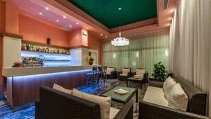 A bar area with a counter, seating, and a large window. - President (San Michele al Tagliamento)