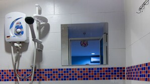 A bathroom with a white sink, a handheld showerhead, and a mirror. - OYO 89891 1st Inn Hotel Subang (Subang Jaya)