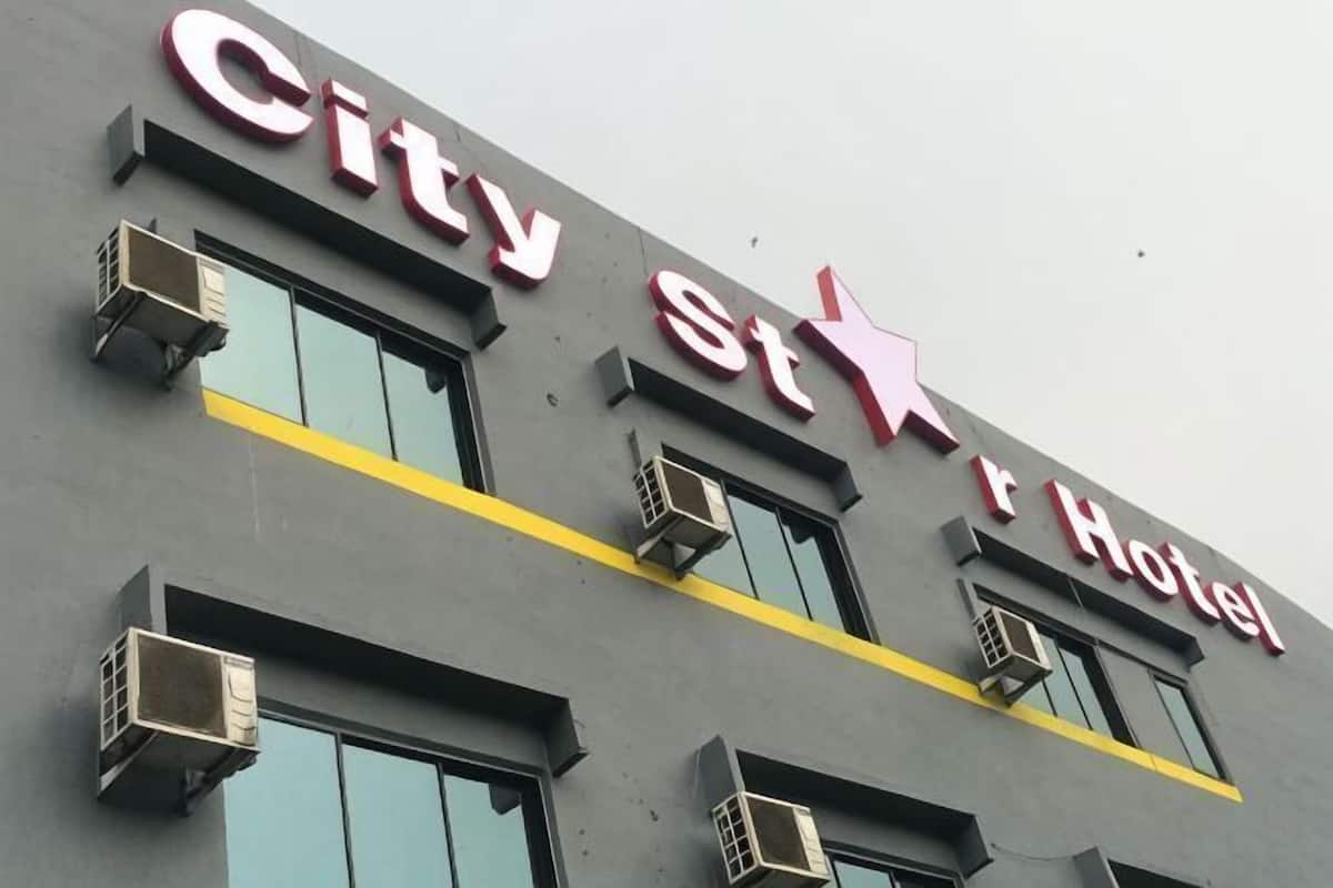 A building with a sign that reads 'City St Hotel' and multiple air conditioning units.
