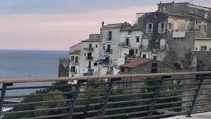 A coastal building with multiple balconies overlooking the sea.