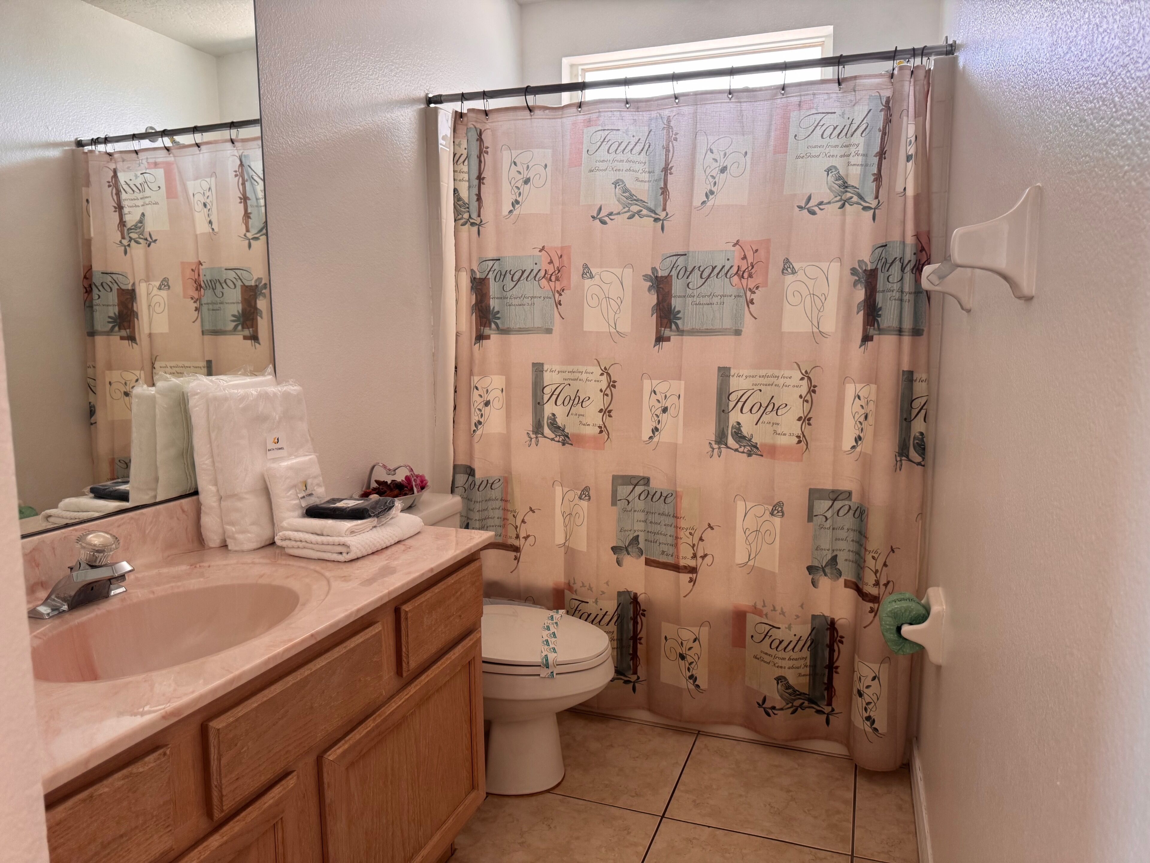 A bathroom with a vanity, sink, and toilet.