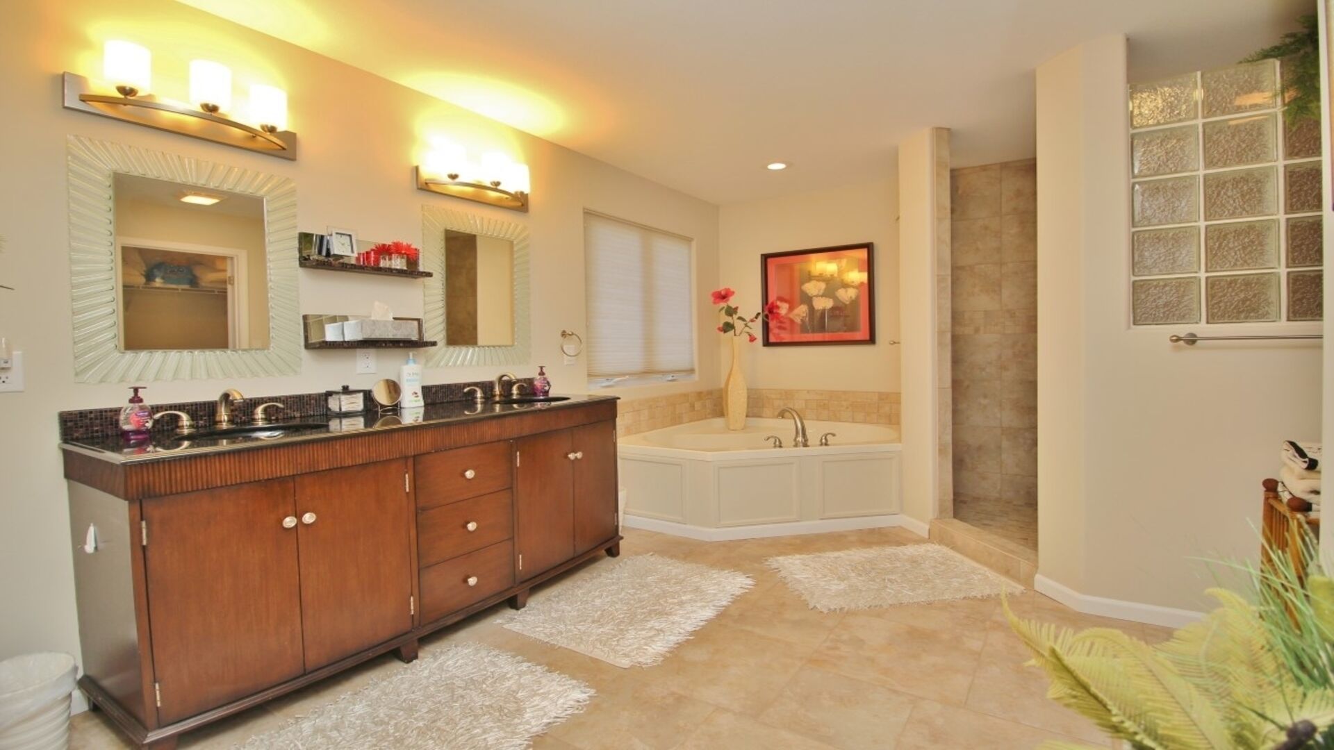 A modern bathroom with a double vanity, a freestanding bathtub, and a large mirror.