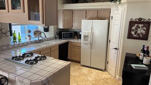 A kitchen with a stove, microwave, refrigerator, and a sink. - Lake House to RELAX and Have FUN!!  FREE Wi-Fi. (Lake Havasu City)