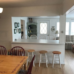 Enjoy cooking in this well-equipped kitchen with a central island and bar stools, featuring an oven and ample counter space.
