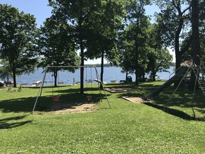 Enjoy a peaceful retreat surrounded by lush greenery and a serene lake view.