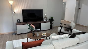 Two-Bedroom Luxury Suite | Living area | 50-inch TV with digital channels