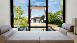 A modern room with a large sliding glass door leading to an outdoor area with a pool and patio furniture. - The Mangrove Resort Hotel Sanya (Sanya)