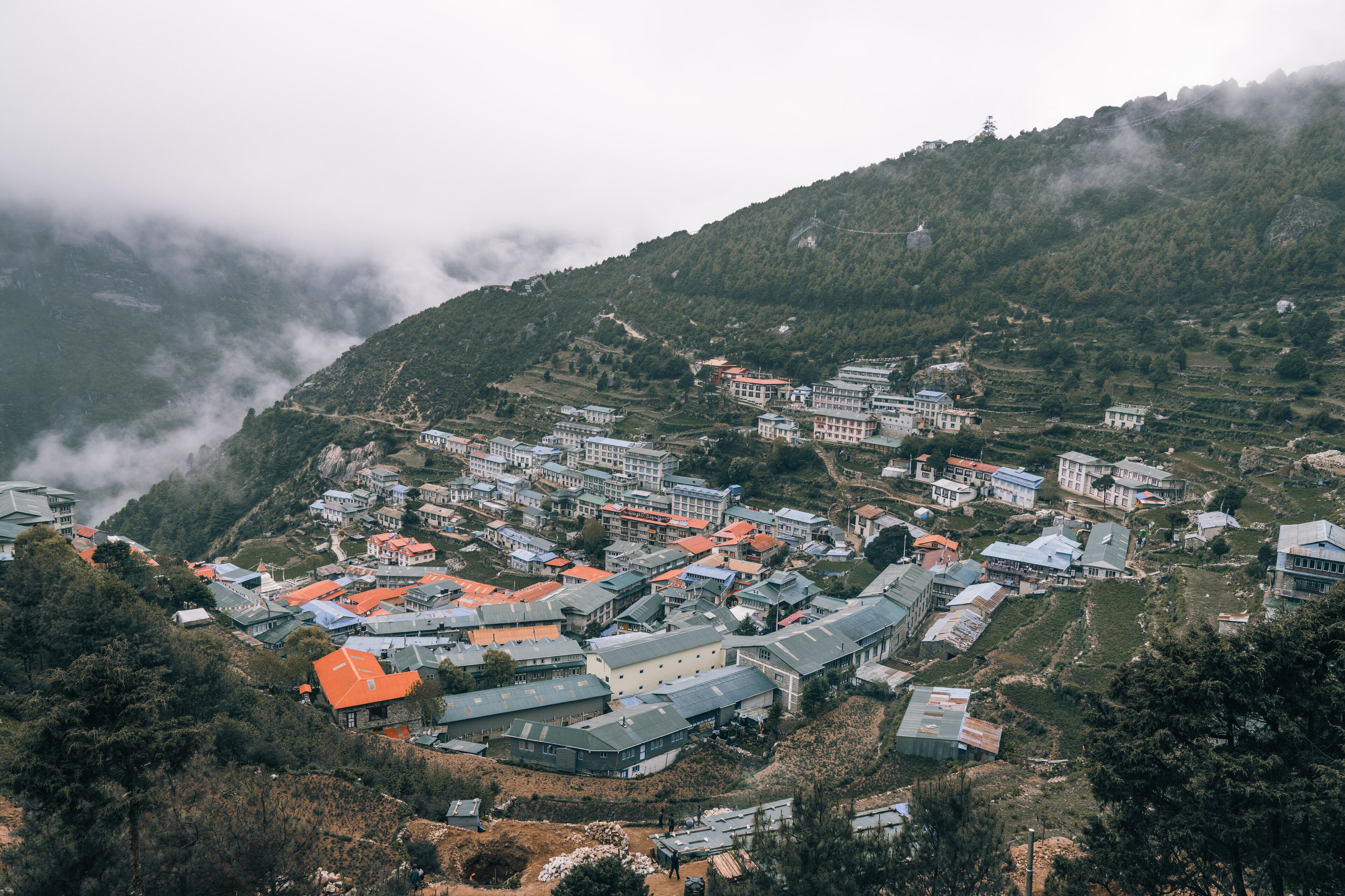 A hillside village with traditional buildings and terraced fields.