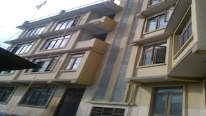 A multi-story building with balconies and large windows. - Bodhi Guest House (Kathmandu)