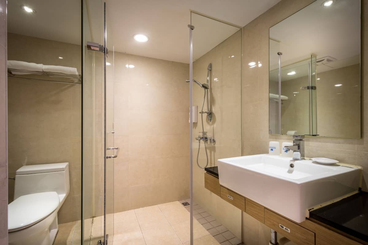 Shower, hair dryer, slippers, towels