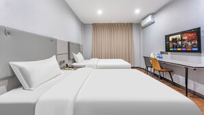 A hotel room with two beds, a desk, a chair, a TV, and an air conditioning unit. - Kaixin Express Hotel (Shenzhen)