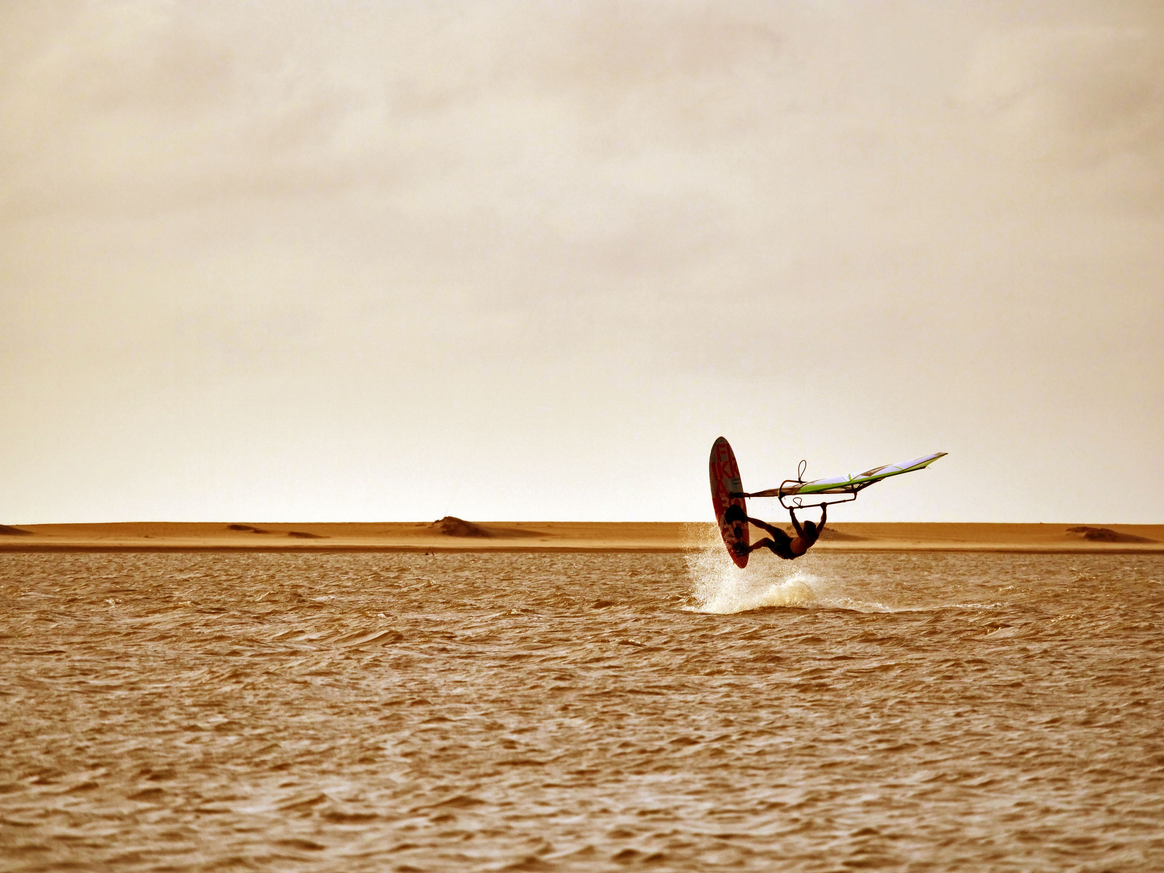 A person windsurfing on a large body of water.