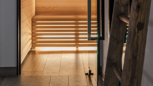 A wooden interior with a staircase leading to a higher level.