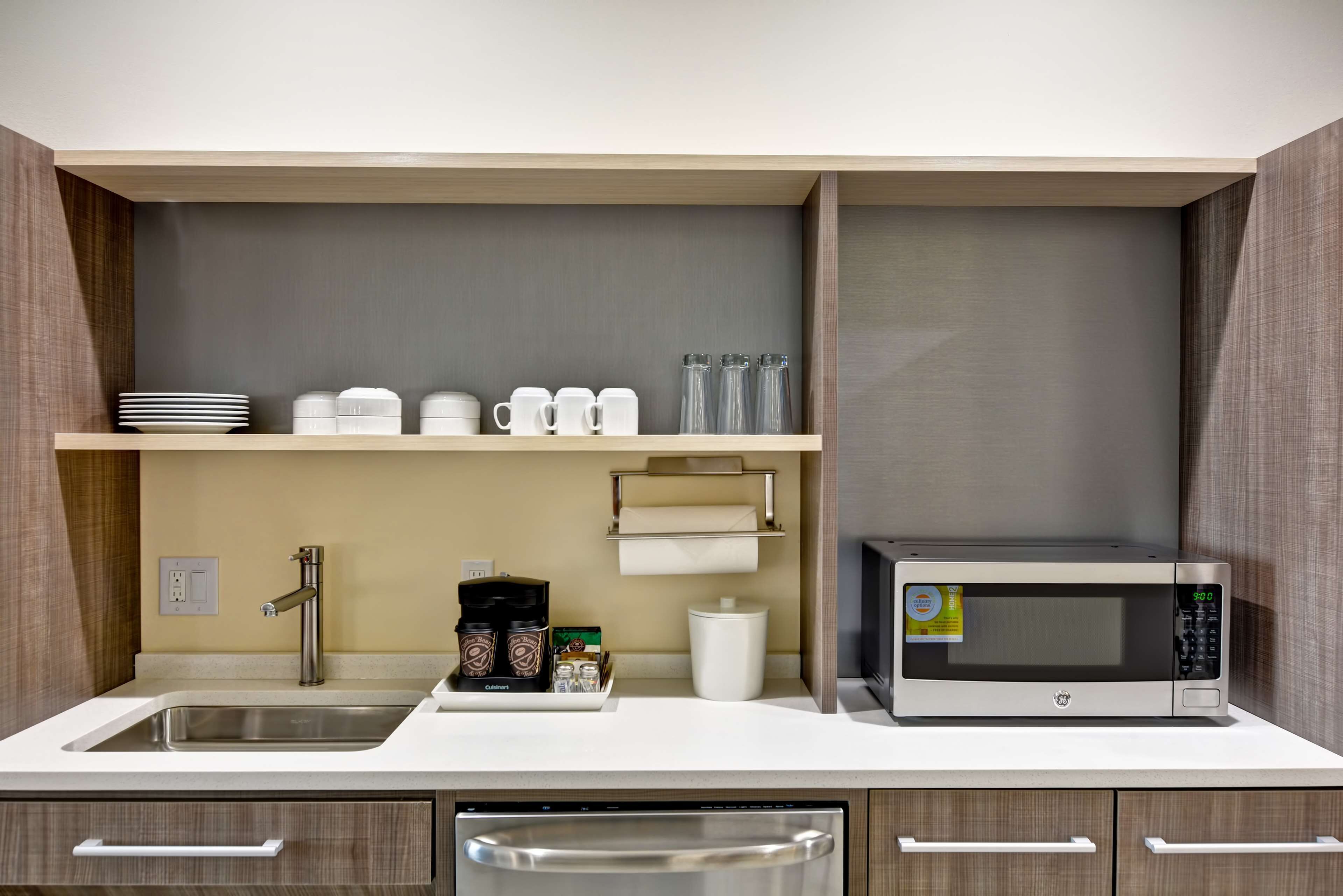 full-sized fridge, microwave, dishwasher, cookware/dishes/utensils