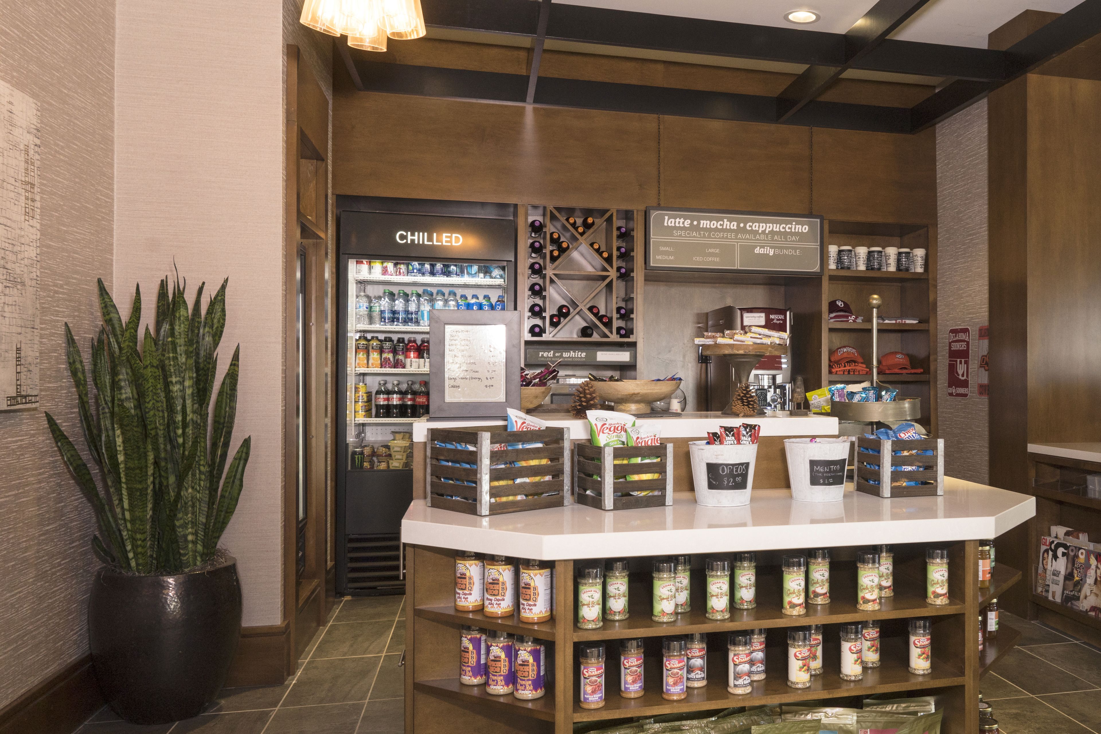 A coffee shop counter with a variety of coffee beans and a 'CHILLED' section.