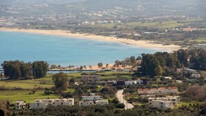 A coastal town with a beach, residential buildings, and a clear view of the sea. - Daphne-Morfi Village (Apokoronas)