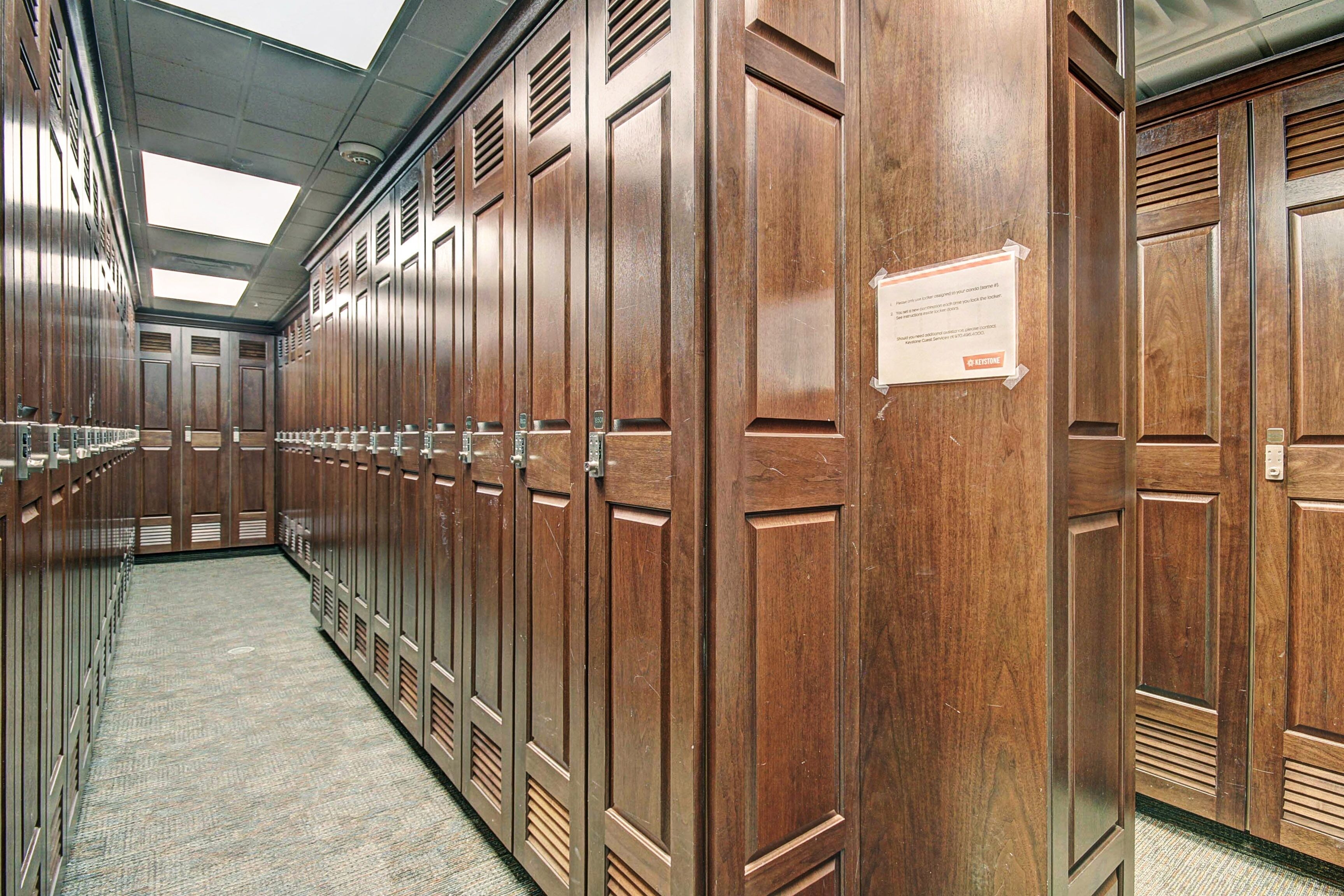 A row of wooden lockers in a hallway with a ceiling skylight.