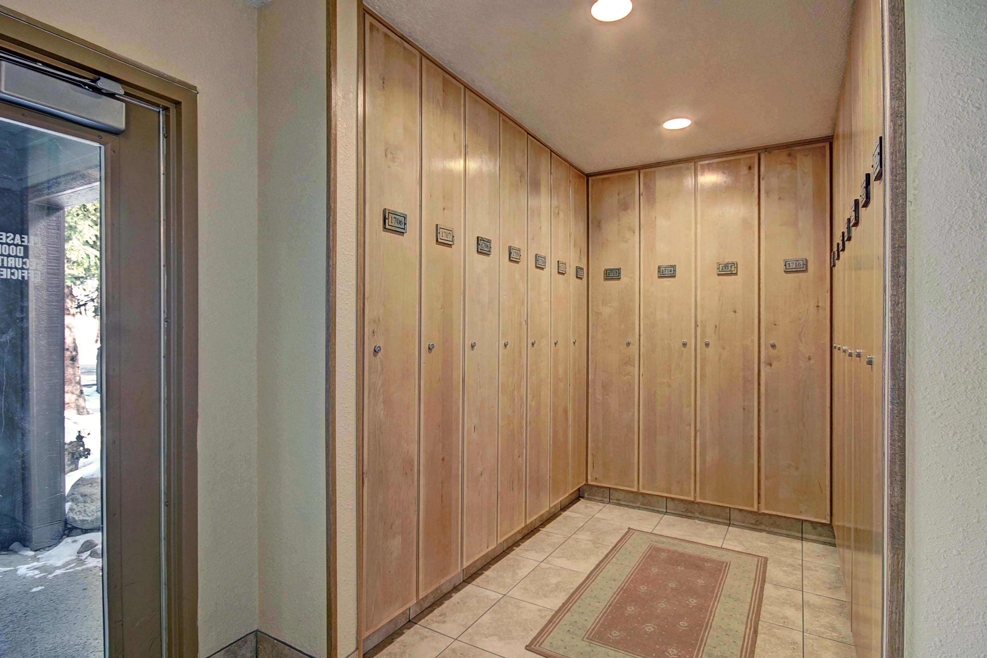An elevator with wooden walls and numbered doors, leading to individual rooms.