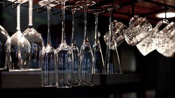 A collection of wine glasses hanging from a rack.