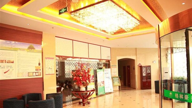 A hotel lobby with a chandelier, seating area, and a reception desk. - GreenTree Inn Taizhou Xinghua Anfeng Runan Garden Express Hotel (Taizhou)