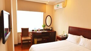 A hotel room with a bed, a desk, a chair, a TV, and a window. - GreenTree Inn Jiaxing Pinghu Zhapu Jiulong Mountain Express  Hotel (Jiaxing)