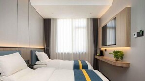 A hotel room with two beds, a flat-screen TV, a bedside table, and a large window with curtains. - Greentree Alliance Nicheng Nanlu Rd. Renmin Rd. Ho (Shanghai)