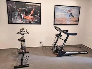 A gym with a stationary bike and a treadmill. - Greentree Inn Shanghai Jiading Dazhong International Auto City Business Hotel (Shanghai)