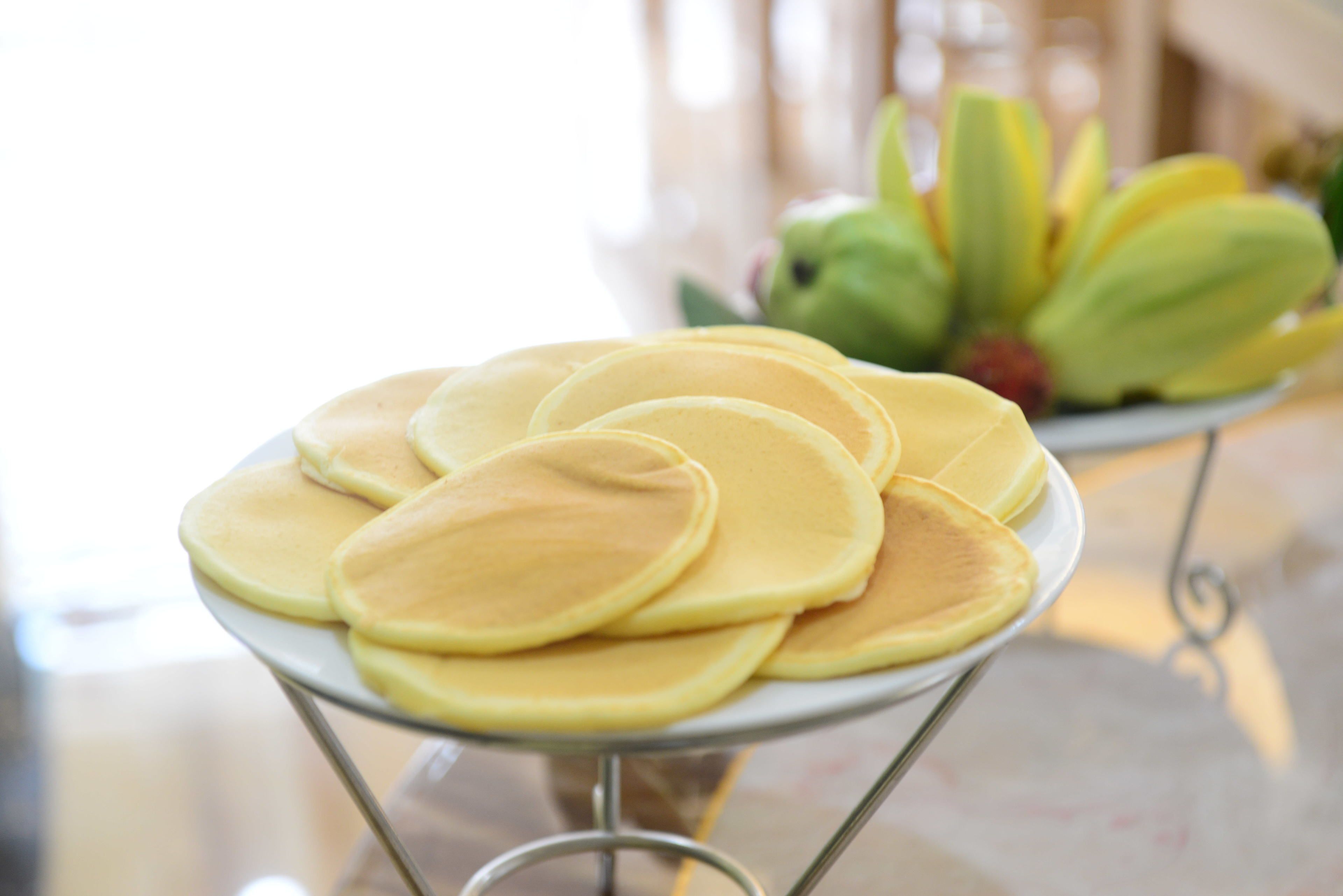 A plate of pancakes on a metal stand.