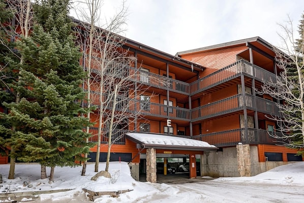 A multi-story building with a red facade and balconies.