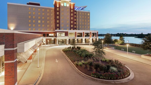 A hotel with a modern design, featuring a large building with multiple floors and a prominent entrance. - Embassy Suites by Hilton Wilmington Riverfront (Wilmington)