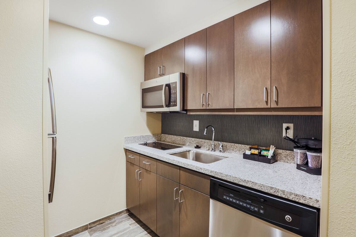 full-sized fridge, microwave, stovetop, coffee/tea maker