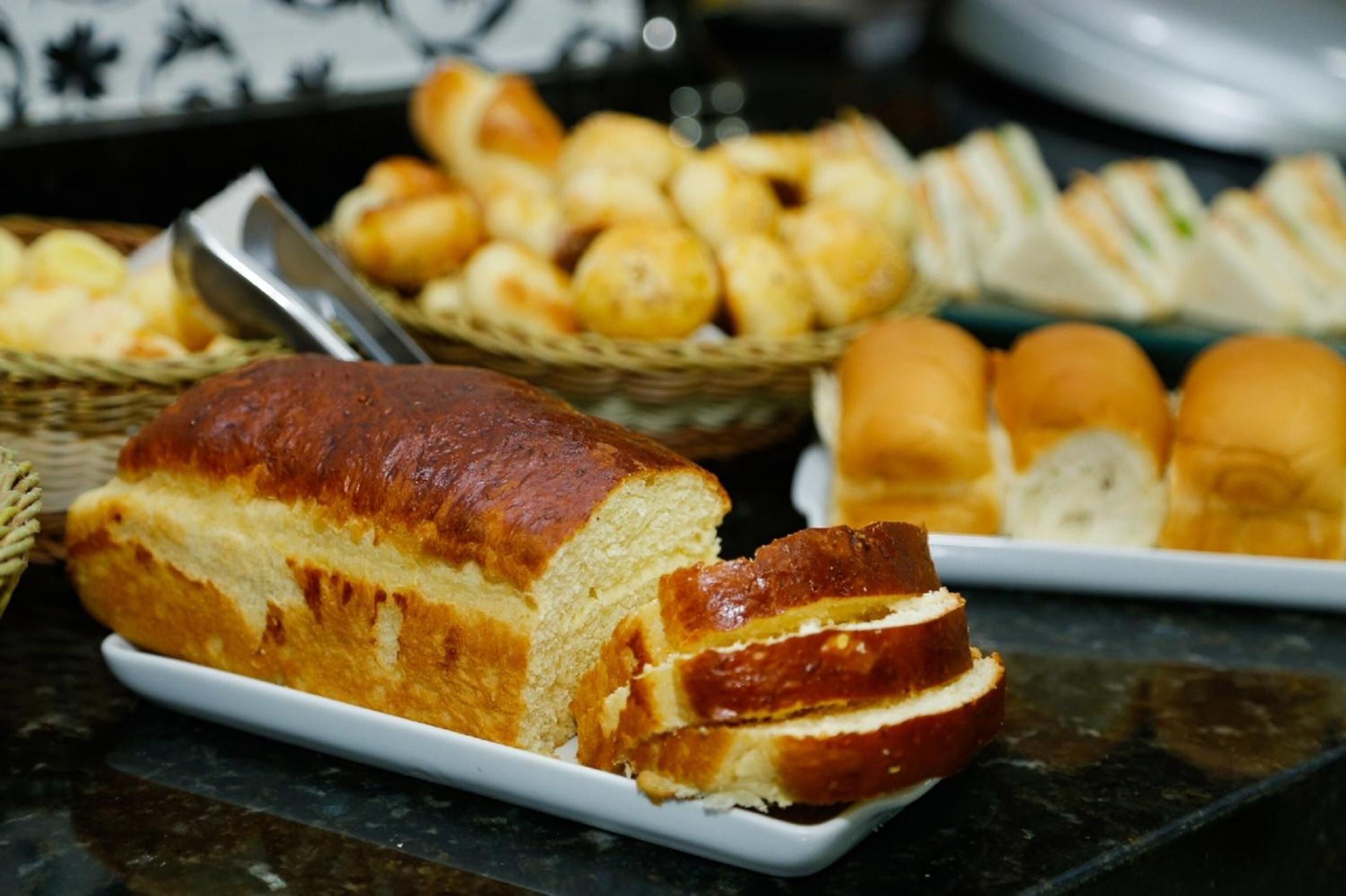 A variety of breads and pastries on a table.