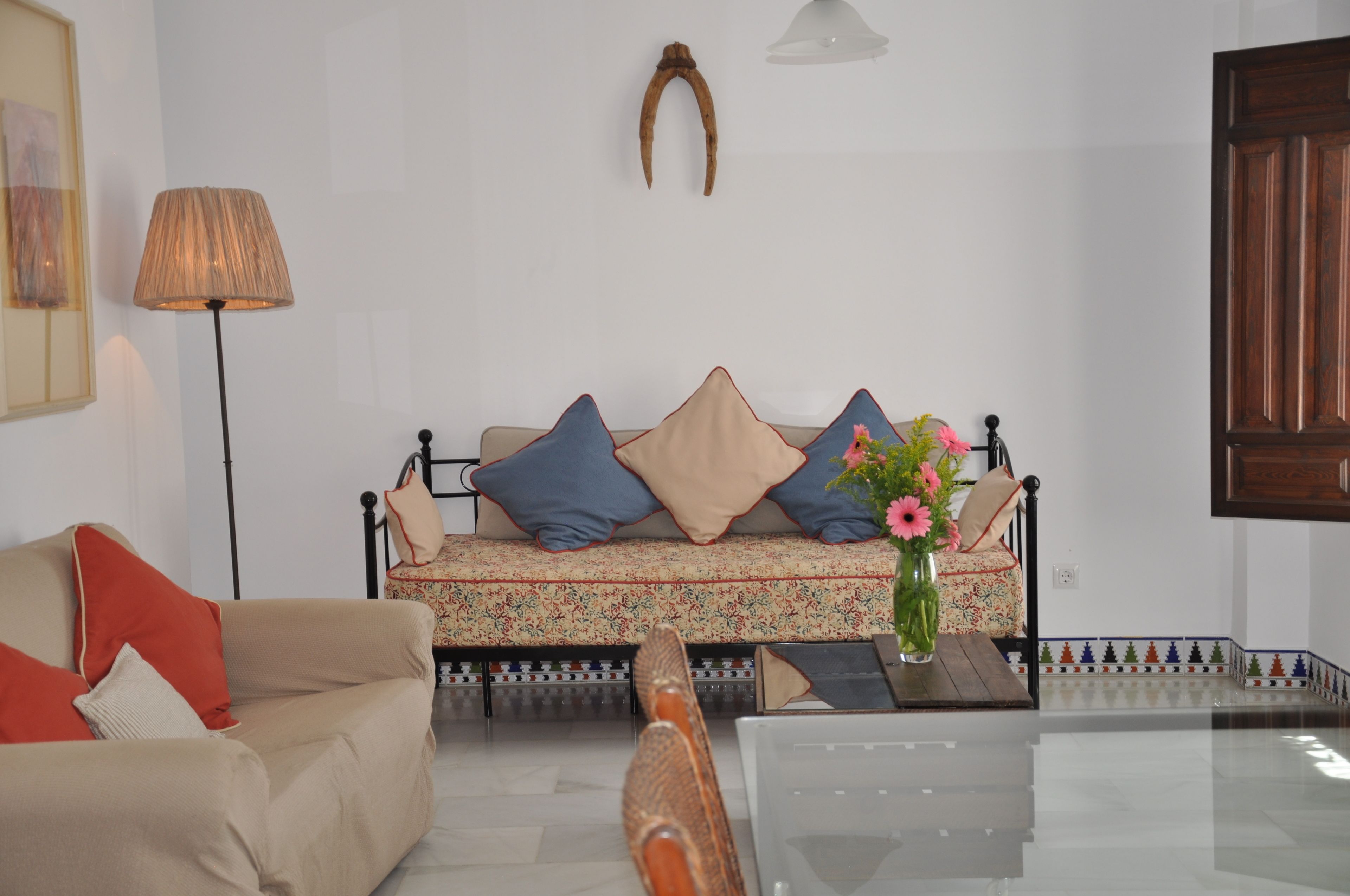 A living room with a sofa, a coffee table, and a lamp.