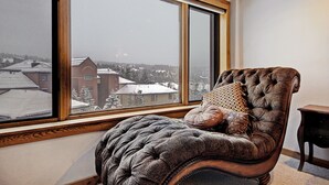 A room with a large window, a tufted armchair, and a small table. - Ski-in/ski-out Studio W/snowy Alpine Views - Walk To Main St Studio Bedroom Condo by RedAwning (Breckenridge)