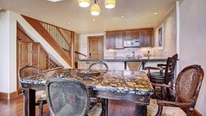 A spacious kitchen with granite countertops, wooden cabinets, and a central island. - 2 BR Condo at The Lodge at Vail View of Gore Range by RedAwning - Save 20% on 7+ Nights! (Vail)