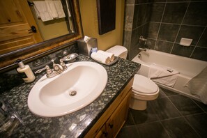 A bathroom with a sink, toilet, and bathtub. - Stay in Comfort while Enjoying Valley Views by RedAwning (Park City)