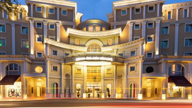 A grand hotel facade with classical architecture, large windows, and a prominent entrance. - Rome Palace Deluxe (Sunny Beach)