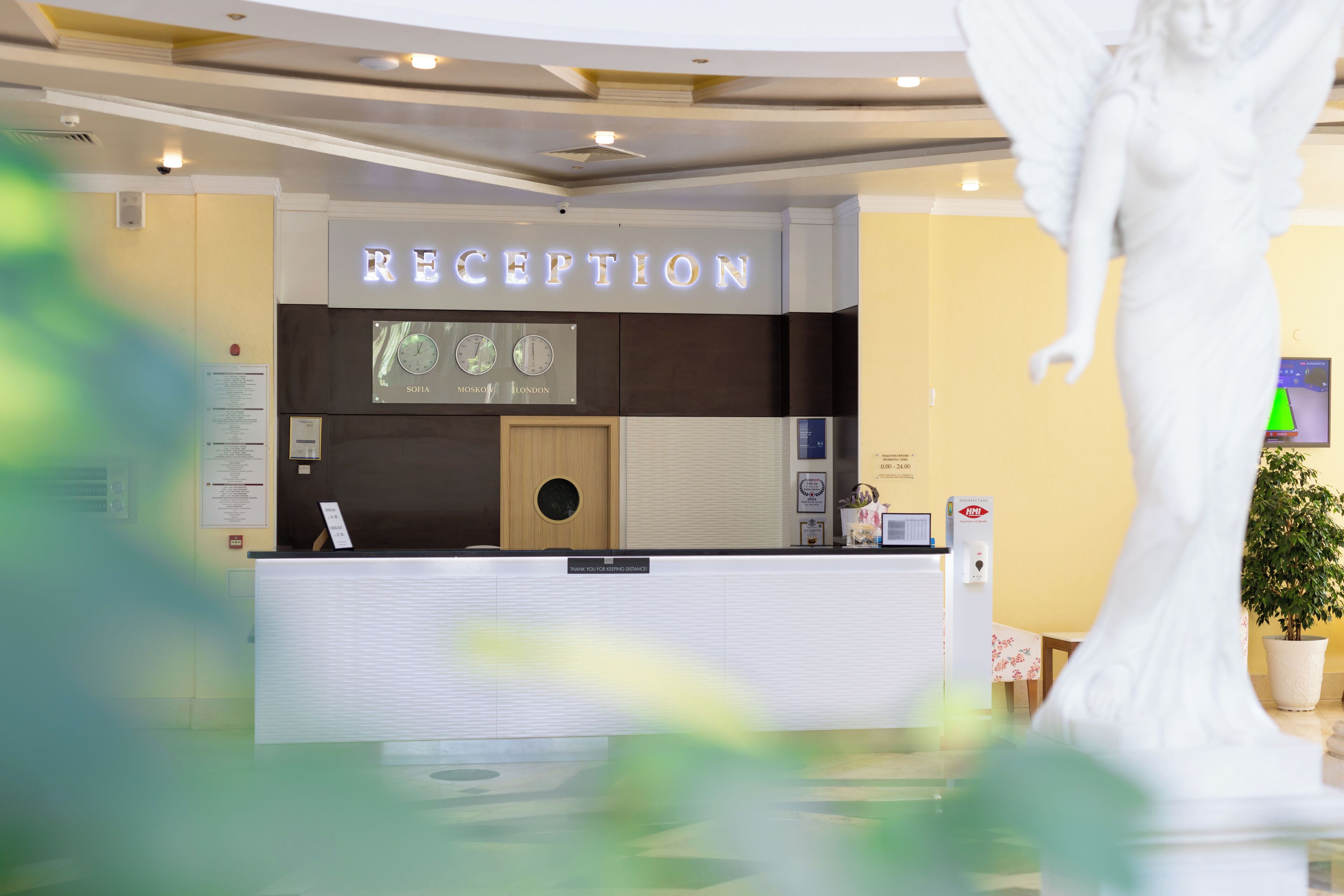 A reception area with a reception desk, a clock, and a sign indicating 'RECEPTION'.