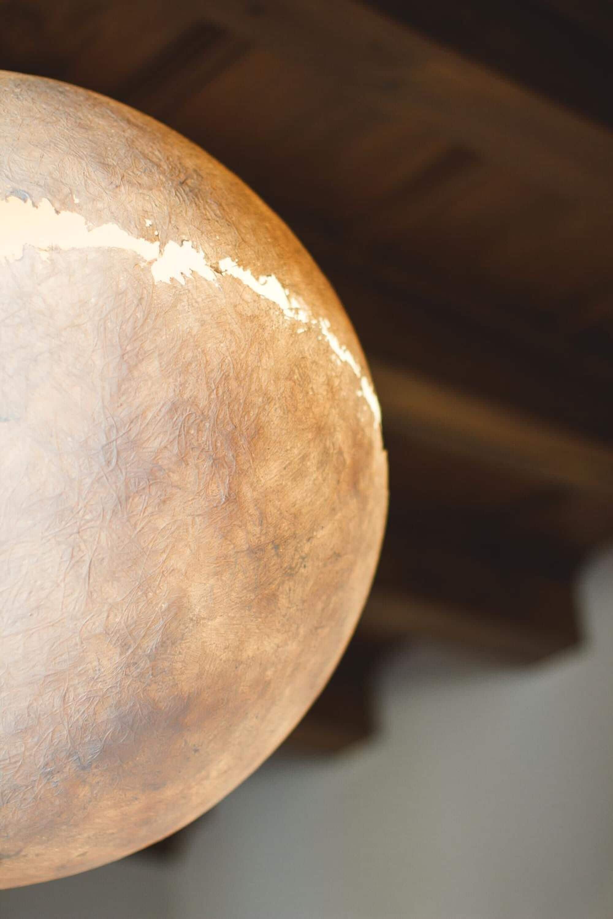 A close-up of a wooden surface with a rough texture and a visible scratch.